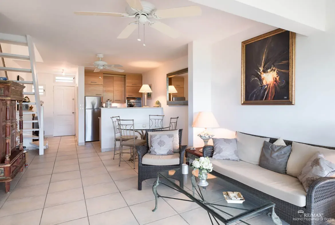 An open-plan layout connects living, dining, and kitchen areas — perfect for entertaining in your Caribbean getaway.