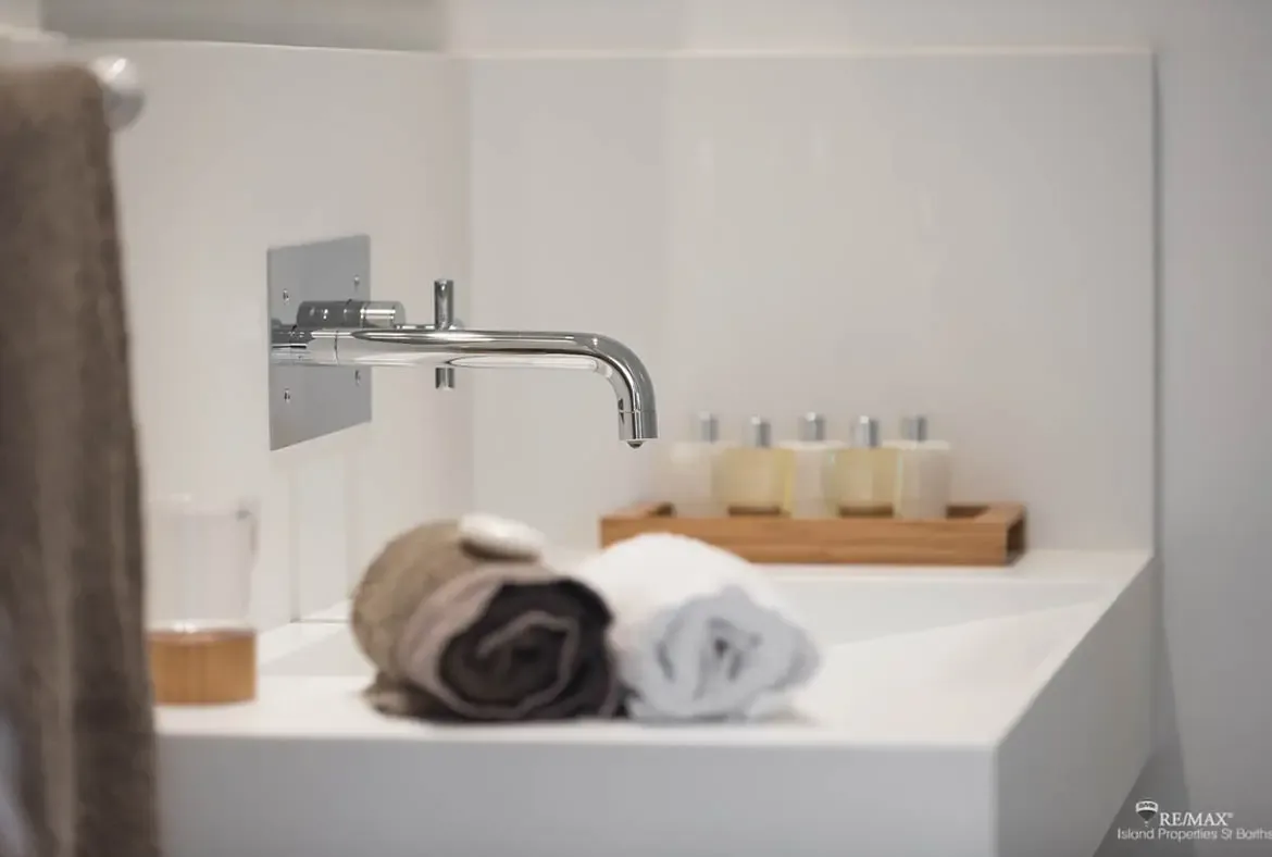 Clean modern vanity details create a calm, spa-like start to your day in St. Barths.