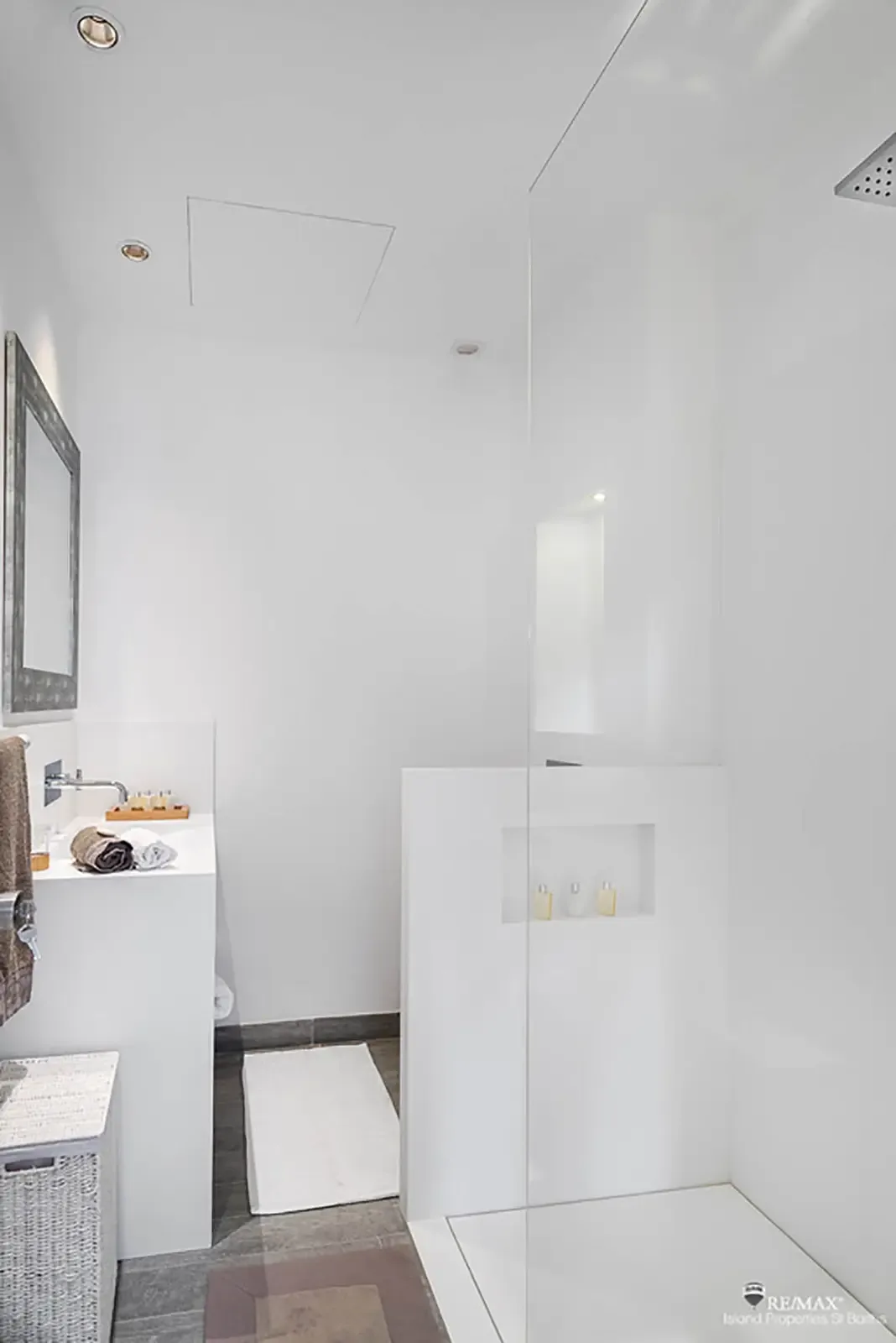 A sleek bathroom with walk-in rain shower and clean modern lines brings spa-like ease to your stay.