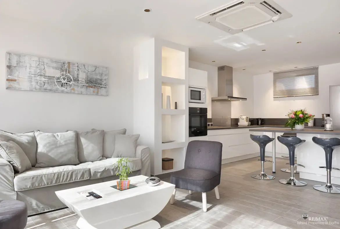 The kitchen island with bar seating makes this modern apartment perfect for casual breakfasts and evening drinks.