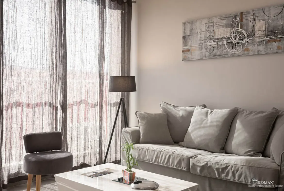 A stylish living room with plush seating and soft natural light — a comfortable base for your St. Barths stay.