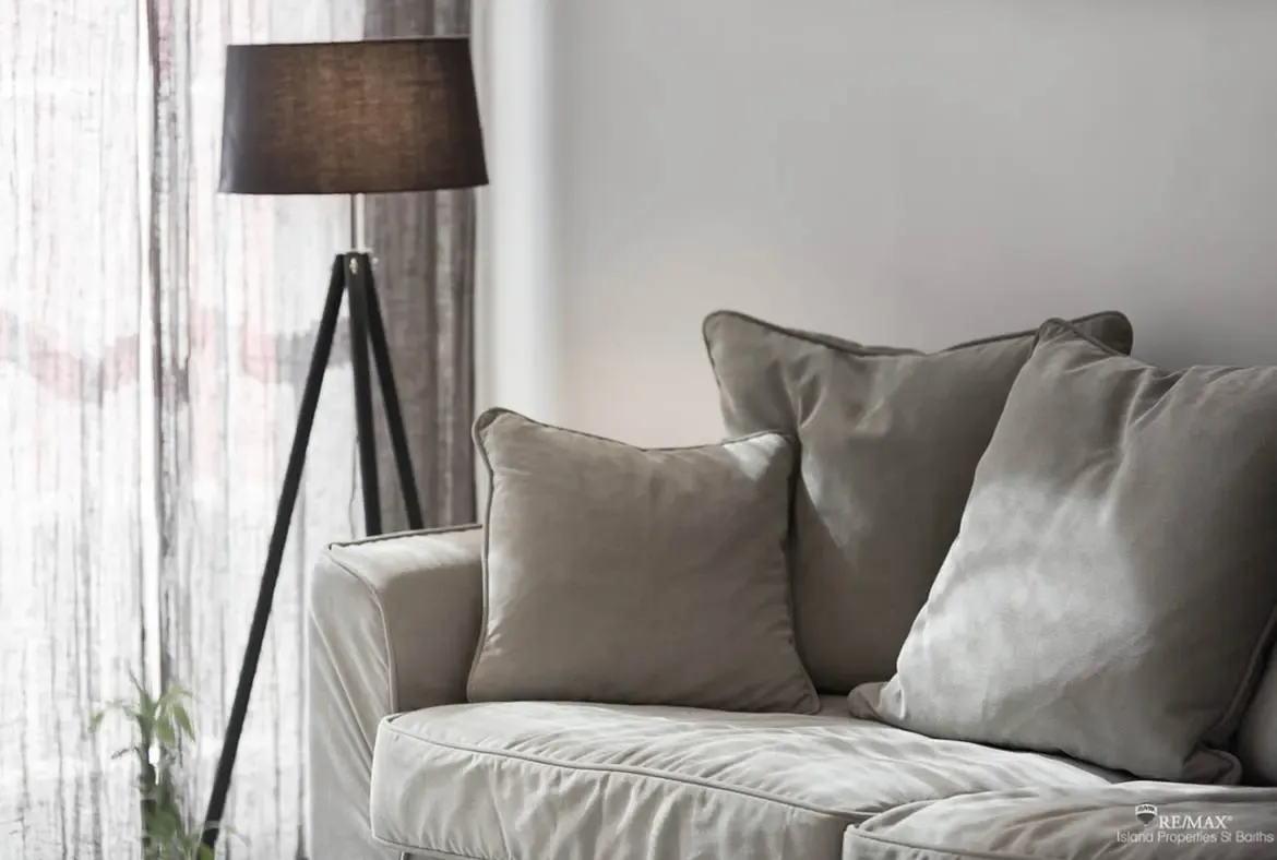 Plush sofa details and soft textures create a cozy, modern space to unwind after a day in St. Barths.