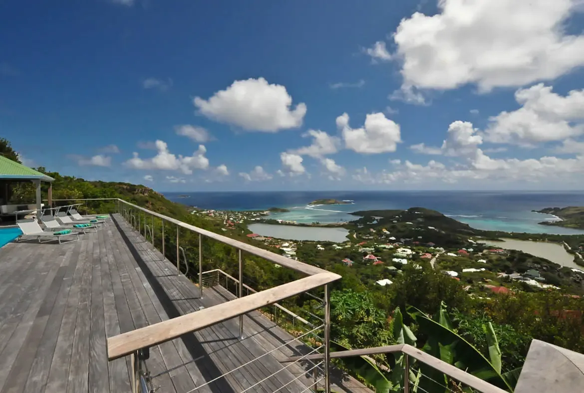 Soak in the luxury of Villa Agave Azul's expansive wooden deck, where uninterrupted ocean panoramas and gentle trade winds create the ultimate Caribbean retreat. Lounge by the pool as you marvel at the vibrant turquoise waters and lush coastal hills of St. Barths, a serene escape designed for pure relaxation.                                                                                                                                                                                        +
 