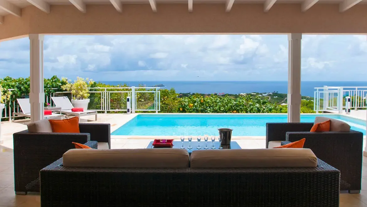 Step onto the plush lounge terrace of Villa Au Coeur du Rocher, where the Caribbean Sea meets the sky in an endless horizon. Sip chilled champagne amid woven wicker seating as tropical breezes and the glimmer of your private infinity pool create a sanctuary of calm.                                                                                                                                                                                                                              +
 