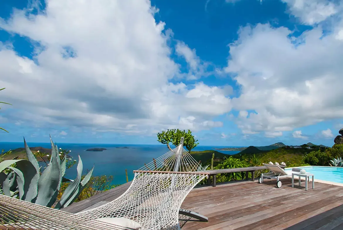 Drift into tranquility in the handwoven hammock on your private deck, where endless turquoise waters meet the horizon and distant islands shimmer under a sky dotted with fluffy clouds. Let the gentle Caribbean breeze and panoramic ocean views melt away every trace of stress.                                                                                                                                                                                                                                              +
 