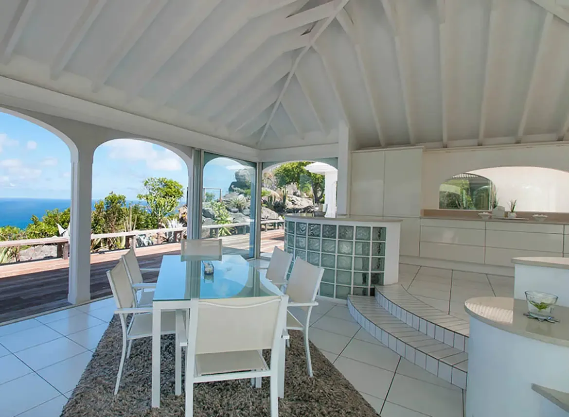 Dine beneath vaulted ceilings as the Caribbean breeze carries the scent of the sea. Savor meals with panoramic ocean views through graceful arches, where modern elegance meets tropical tranquility. This open-concept space seamlessly blends indoor comfort with the island's natural beauty.                                                                                                                                                                                                               +
 