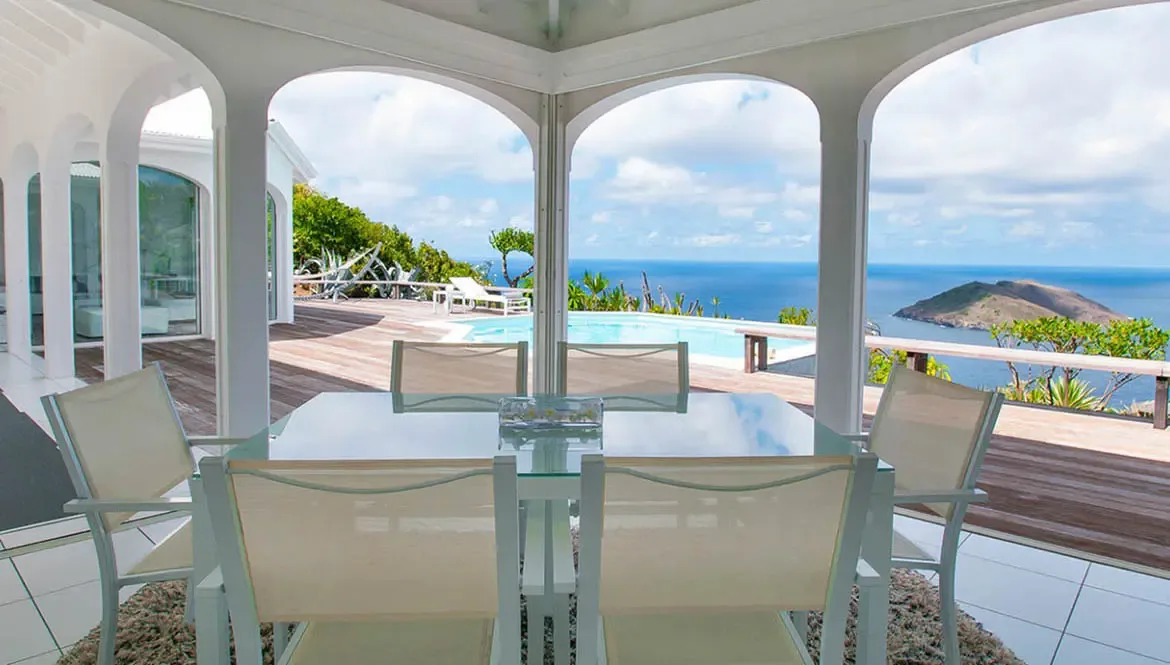 Savor panoramic Caribbean vistas from the open-air dining terrace at Villa Byzance, where breezy elegance meets the rhythm of the sea. Every meal becomes a moment of pure indulgence beneath the bright St. Barths sky, framed by endless ocean horizons and lush hillside greenery.                                                                                                                                                                                                                               +
 