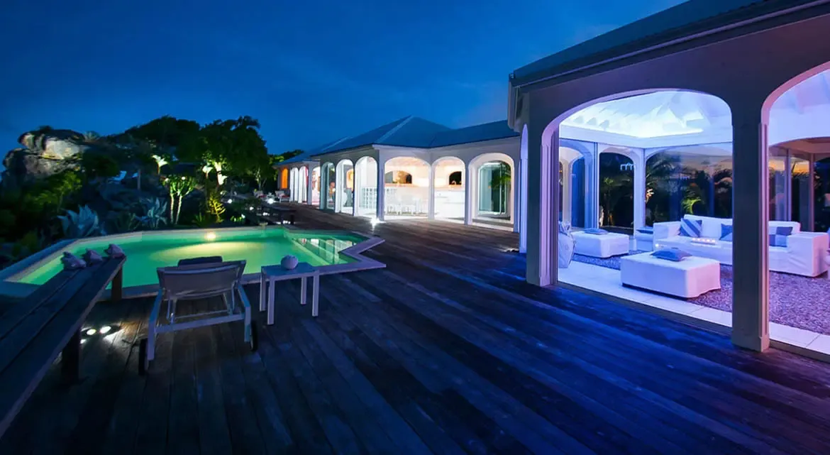 Step onto the vast wooden deck of Villa Byzance as twilight deepens, where the glow of the illuminated pool dances against the indigo sky. Indulge in the seamless flow between open-air living spaces and the serene outdoor oasis, designed for effortless luxury under the stars.                                                                                                                                                                                                                                          +
 