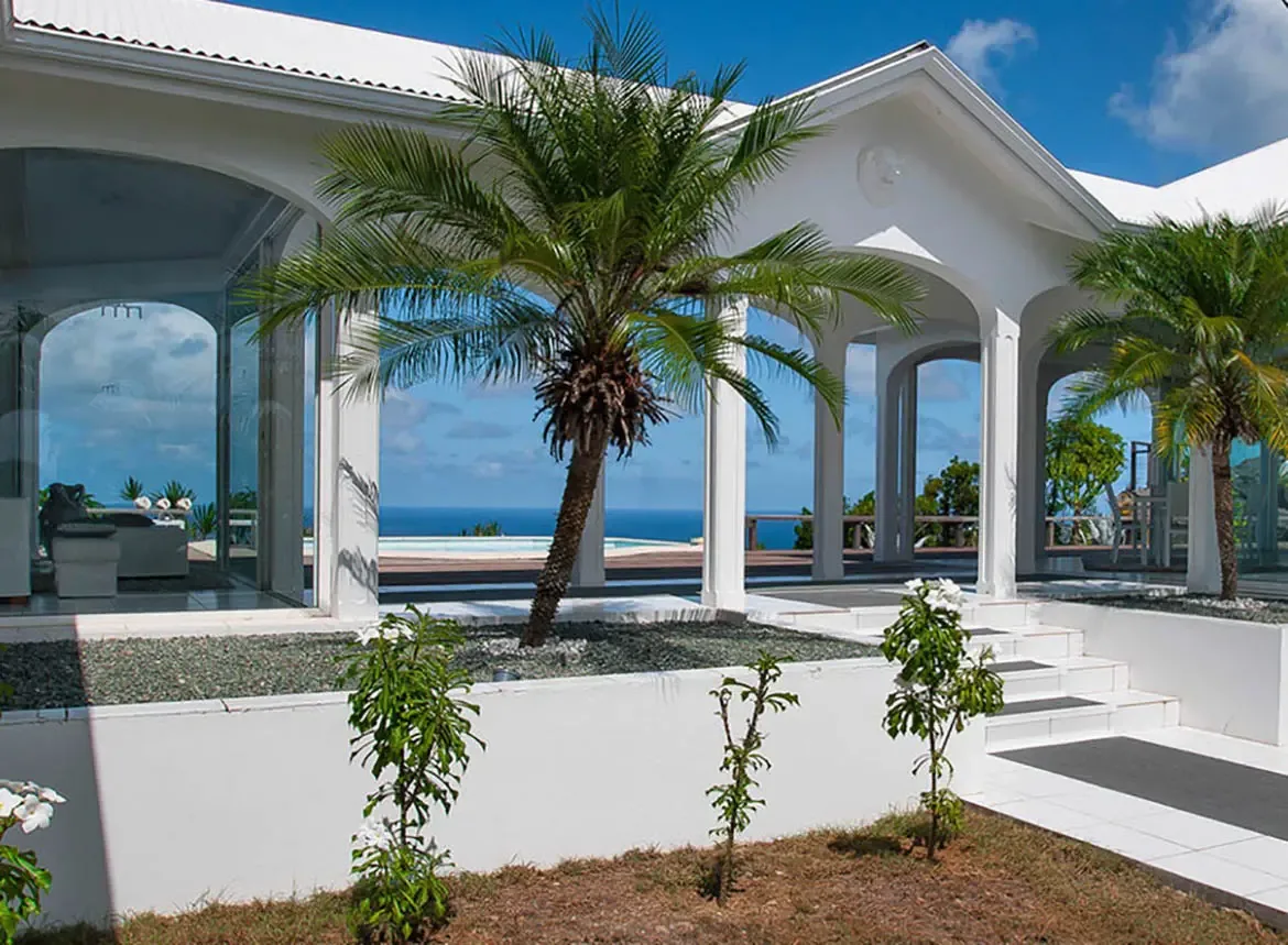 Indulge in the tranquil luxury of Villa Byzance's open-air terrace, where sweeping ocean views and swaying palms create a private paradise. Step from the shaded arches to the sunlit pool deck, embracing the Caribbean's effortless elegance at every turn.                                                                                                                                                                                                                                                     +
 