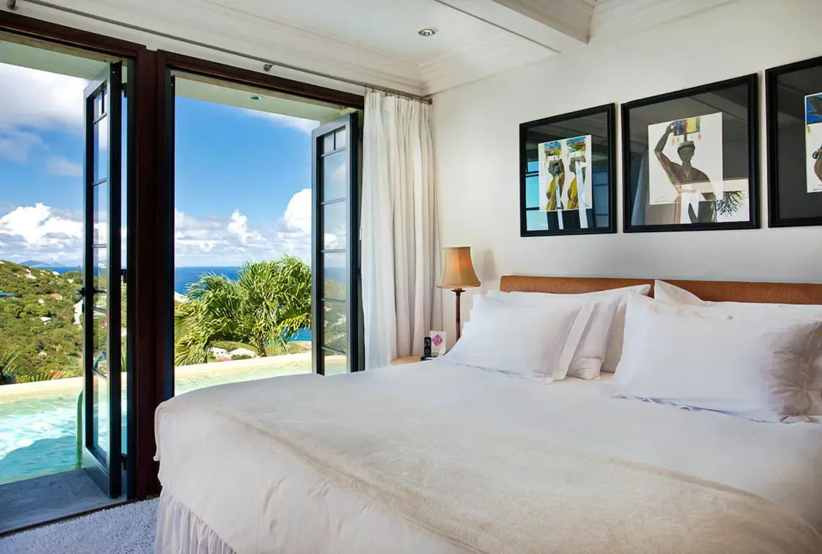 French doors fold back to erase the boundary between bedroom and plunge pool. Step from crisp white linens directly into turquoise water—a hallmark of ultra-luxury accommodation that makes this suite a private destination in itself.