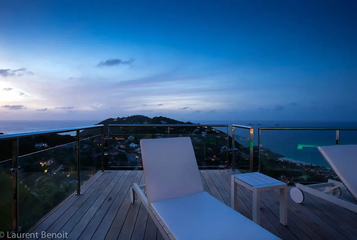 End your day on Villa Donato's expansive terrace, where glass railings disappear to reveal 180-degree views of the Caribbean Sea and twinkling hillside lights. White loungers invite stargazing sessions in complete privacy.