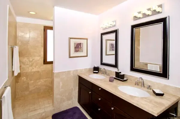 Modern bathroom with double vanity and spacious walk-in shower — designed for shared comfort.