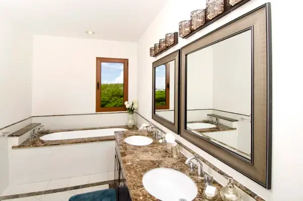 Spa-inspired master bathroom with double vanity and elegant marble finishes — your private sanctuary.