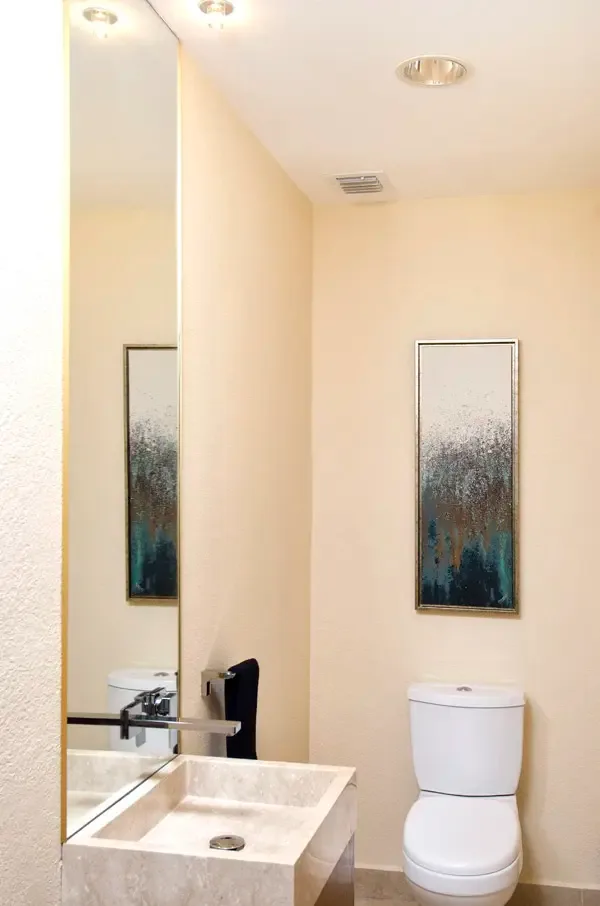 Chic powder room with floating marble vanity — understated elegance for guests.