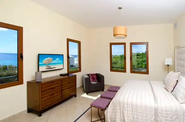 Wake up to breathtaking ocean views in this serene master bedroom with private balcony access.