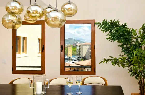 Elegant dining room with golden pendant lights and harbor views — where every meal feels like an occasion.