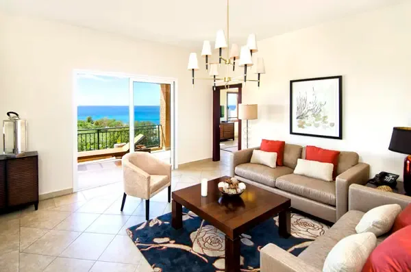 Relax in this light-filled living room where every seat offers a glimpse of the turquoise sea.