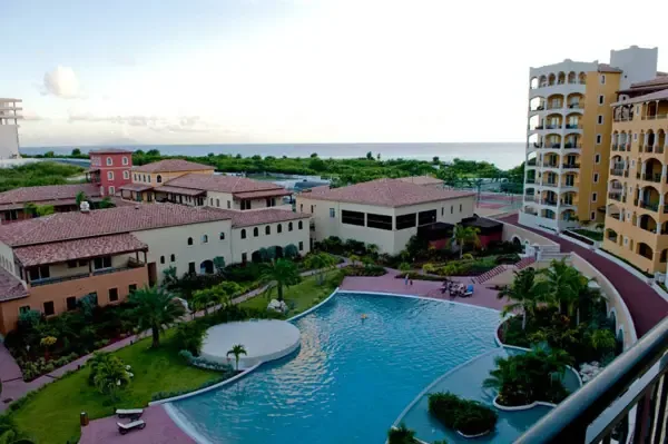 Sparkling pool with expansive terrace and resort views — your private oasis in paradise.