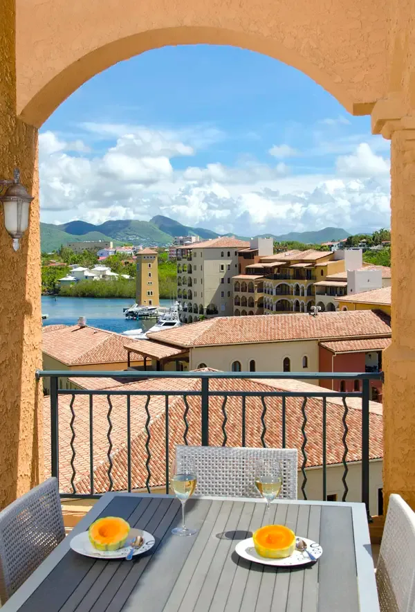 Dine alfresco under a rustic stone arch with the bay and sailboats as your backdrop — a picture-perfect setting.