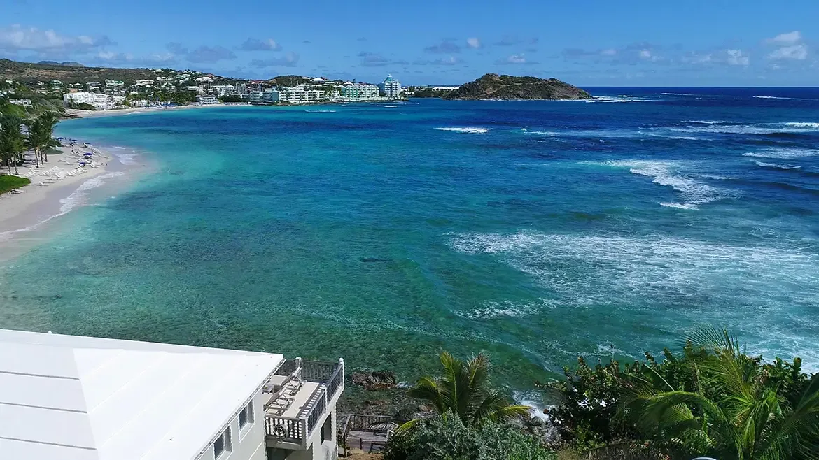 Pristine Dawn Beach awaits with lounge chairs, umbrellas, and impossibly turquoise water.