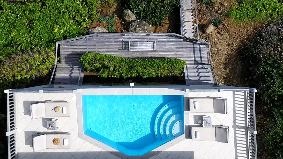 Architectural elegance from above — the custom-shaped pool and tiered hot tub design.