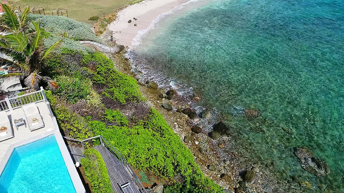 Complete privacy with lush gardens, pool, and private wooden walkway to the beach.