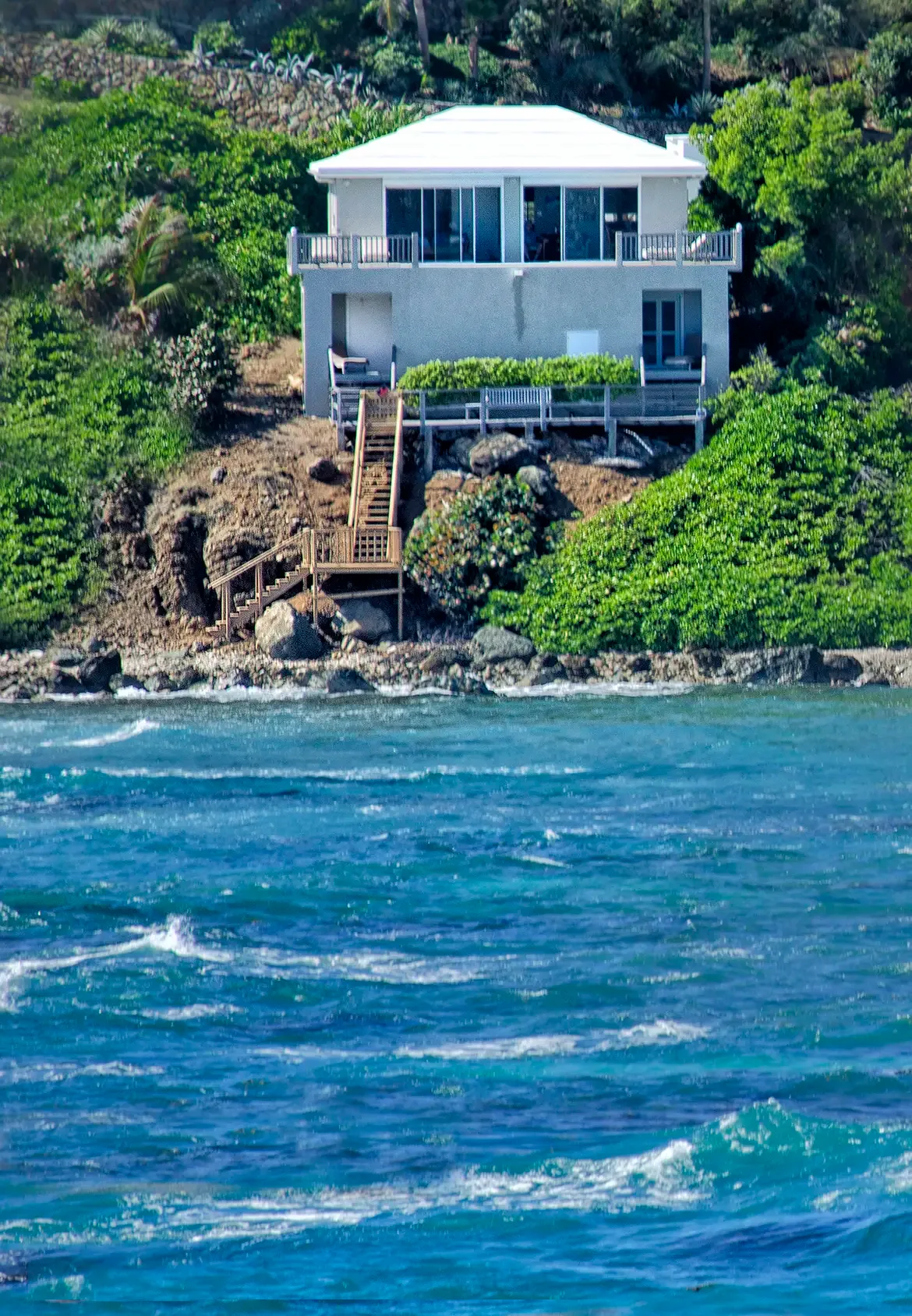 A stunning two-story coastal retreat perched above the rocky shore with endless ocean vistas.