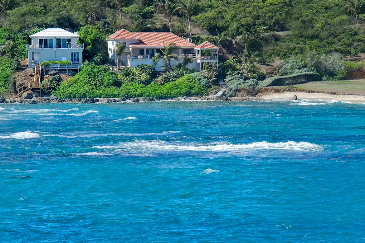 Iconic coastal architecture — two stunning homes nestled into the hillside with ocean panoramas.