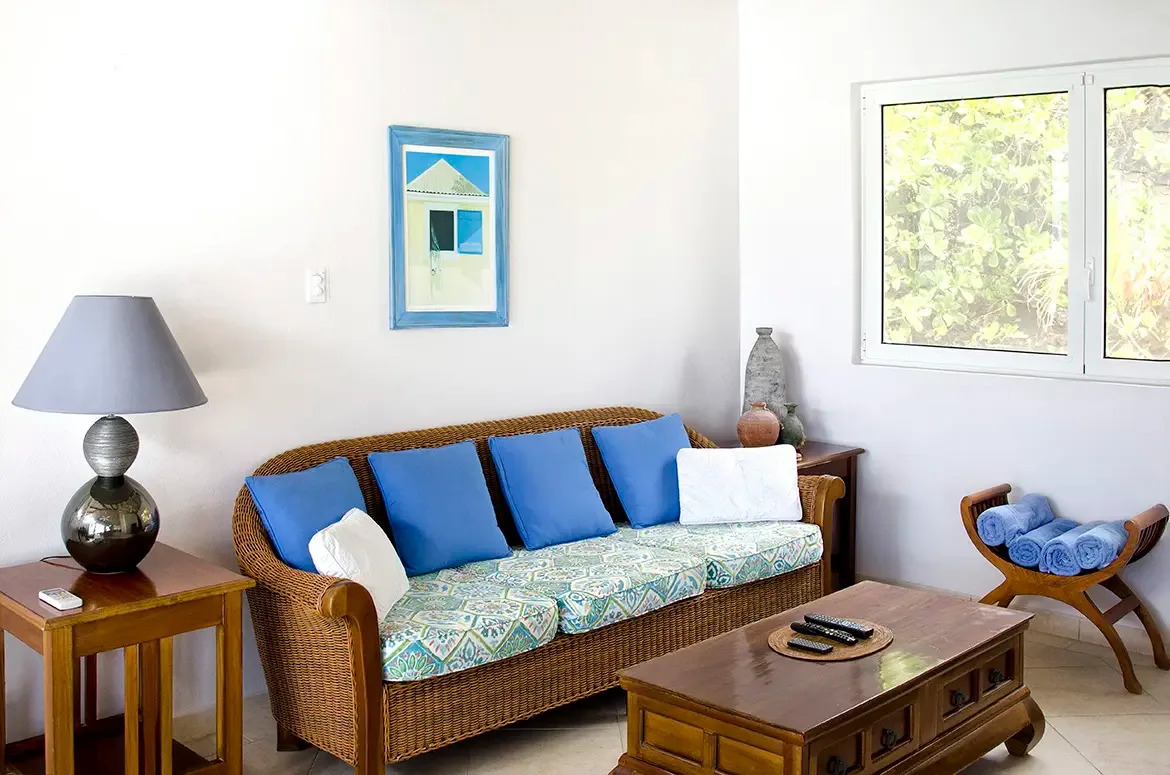 Thoughtfully designed living spaces with coastal charm and views of lush tropical greenery.