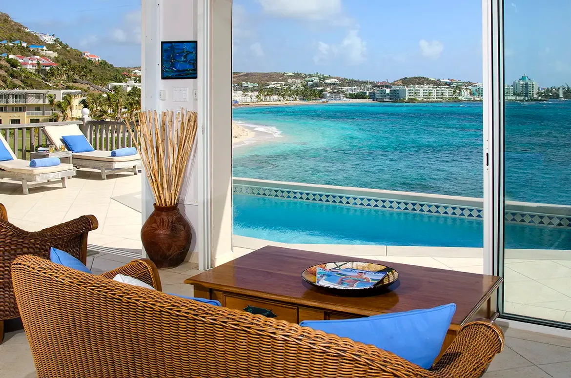 Open-concept living with floor-to-ceiling glass doors that blur the line between indoors and paradise.