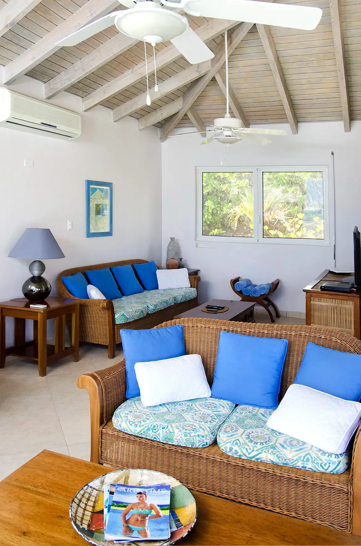Elegant island living with wicker furnishings, tropical accents, and seamless indoor-outdoor flow.