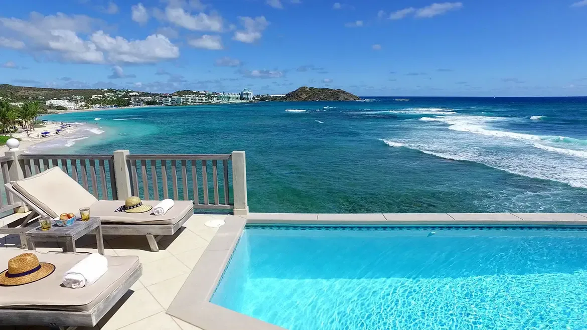 The ultimate pool day — lounge chairs, cold drinks, and endless ocean views at your fingertips.