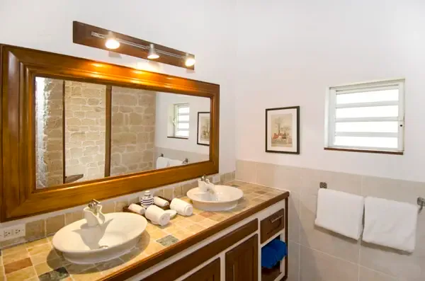Natural stone and artisan tiles — a bathroom that echoes the island's beauty.
