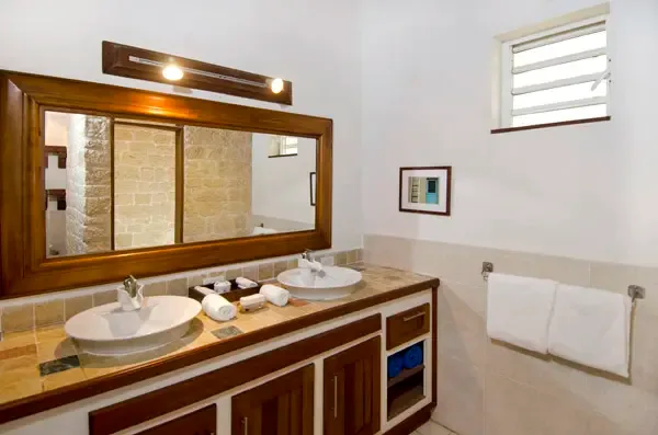 Spa-inspired bathroom with dual vessel sinks and elegant stonework — morning rituals elevated.