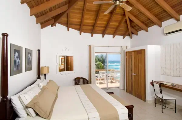 Work with a view — your bedroom desk overlooks the Caribbean Sea through sliding doors.