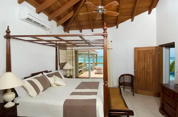 Wake up to paradise — your master bedroom opens directly to ocean views through sliding glass doors.