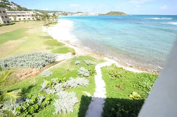 Lush gardens meet ocean breeze — your villa grounds are a private coastal retreat.