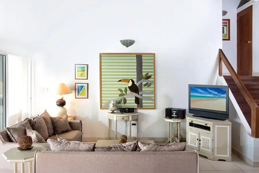 Flooded with natural light — your living room opens directly to terrace views of the Caribbean.
