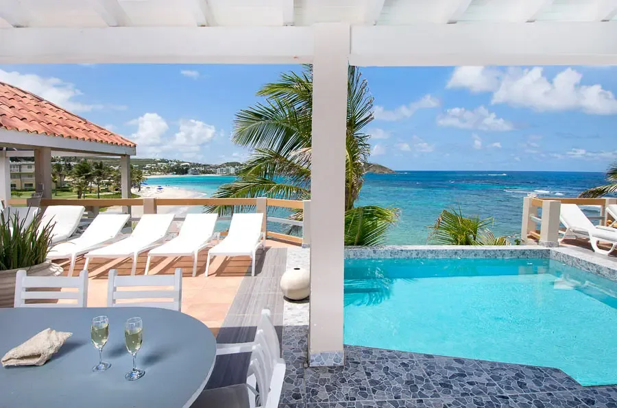 Savor dinner by the pool as the Caribbean sky turns golden — outdoor living at its finest.