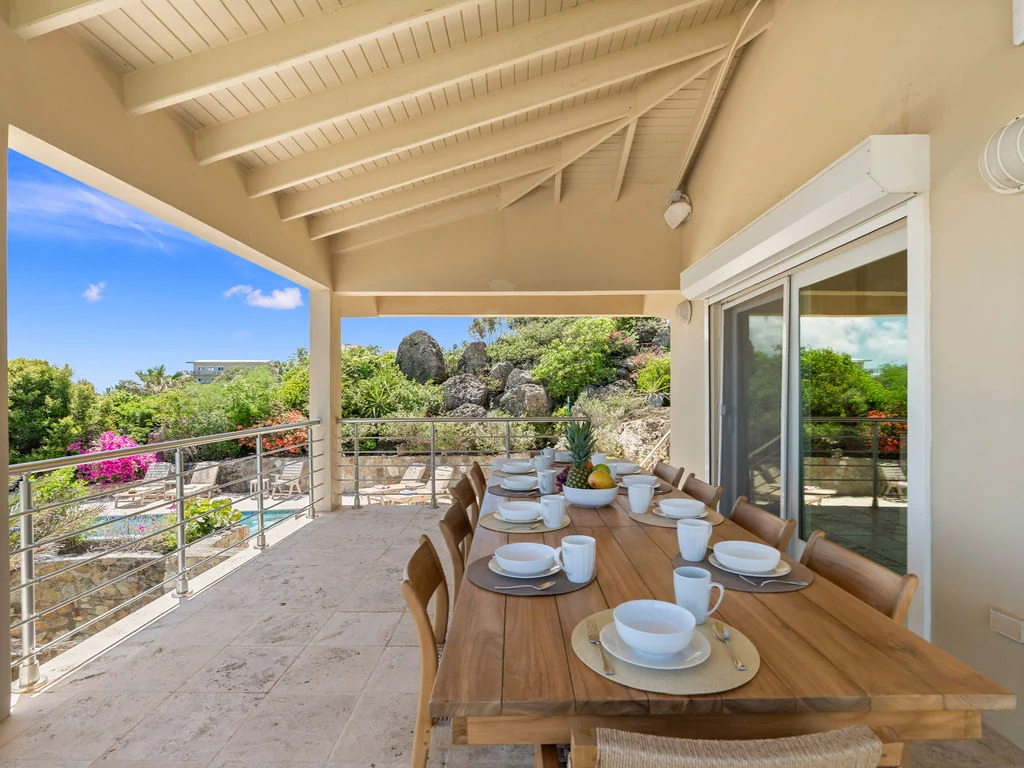 Covered outdoor dining terrace with ocean views