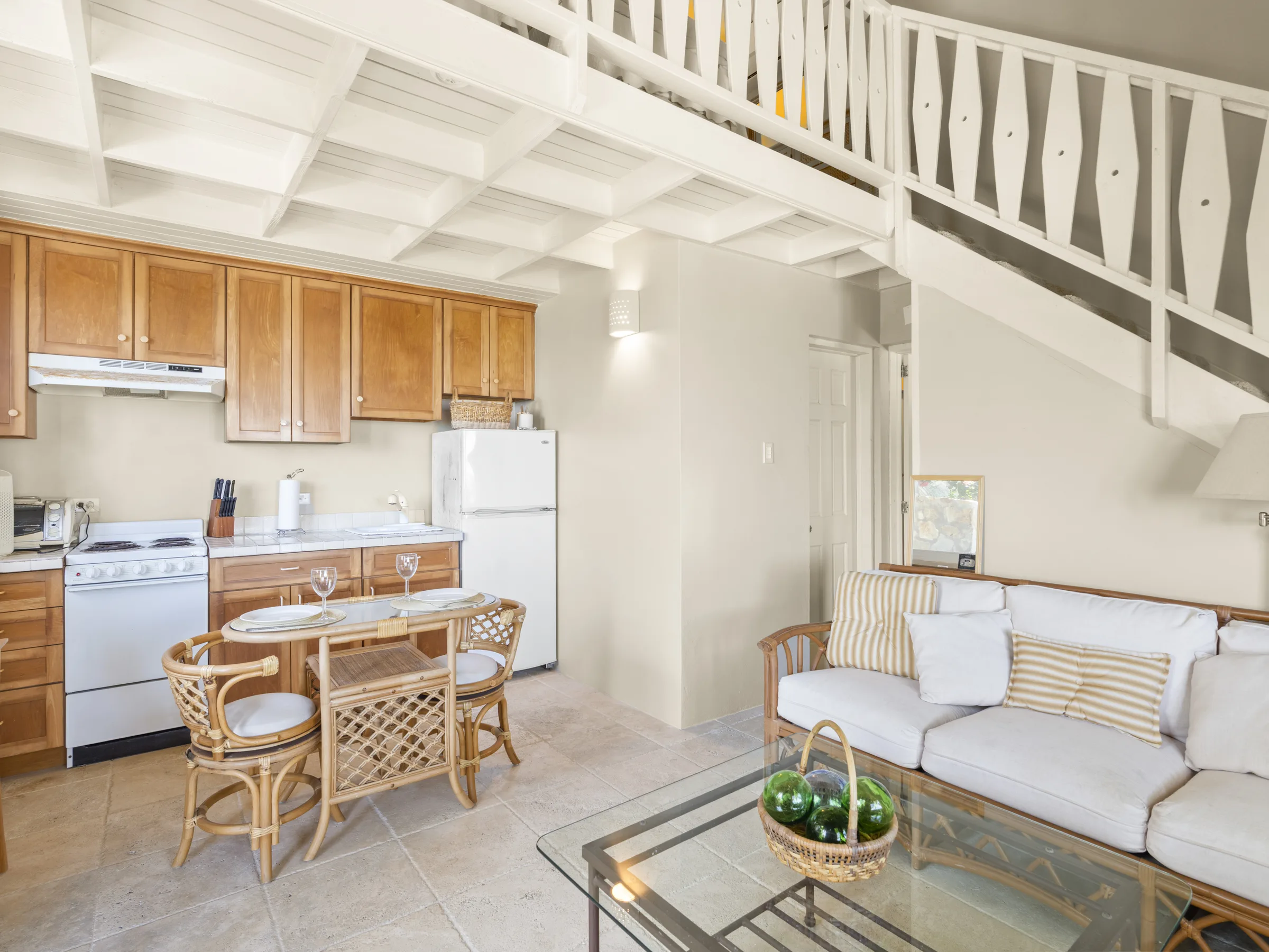 Apartment open-plan living area, kitchenette and loft staircase