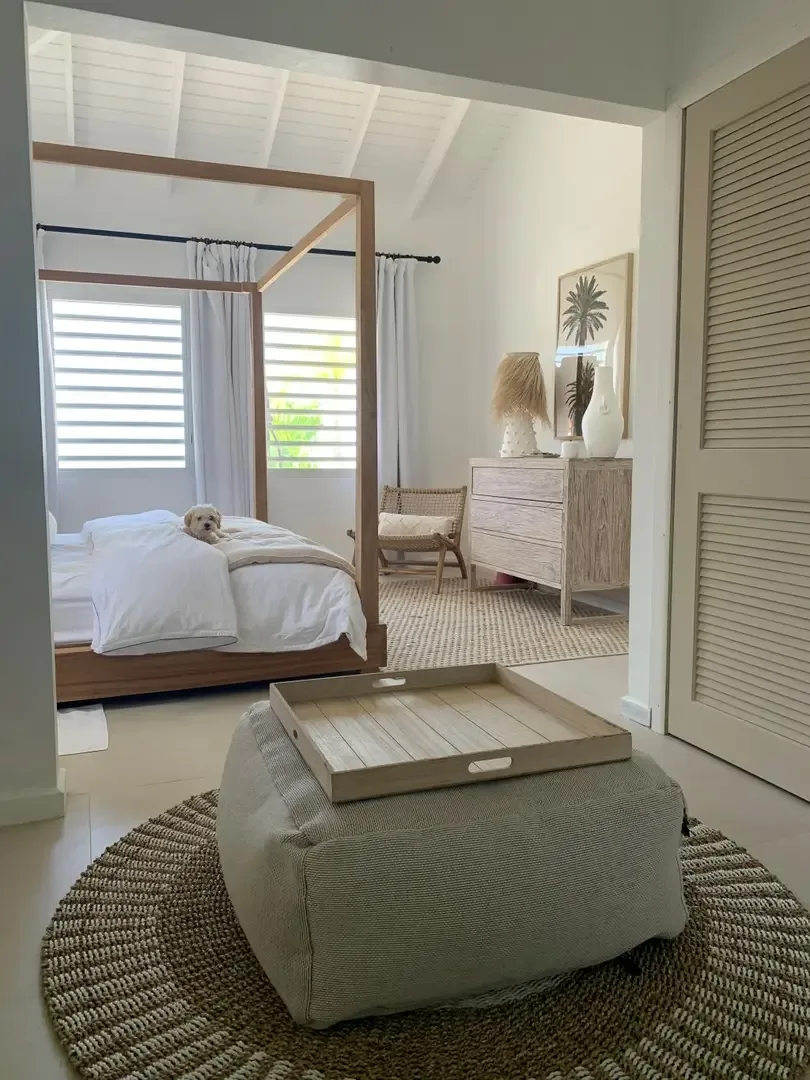 A serene guest bedroom with natural light, woven accents, and a cozy spot for afternoon naps.                                                                                                                                                                                                                                                                                                                                                                                                                                  +
 