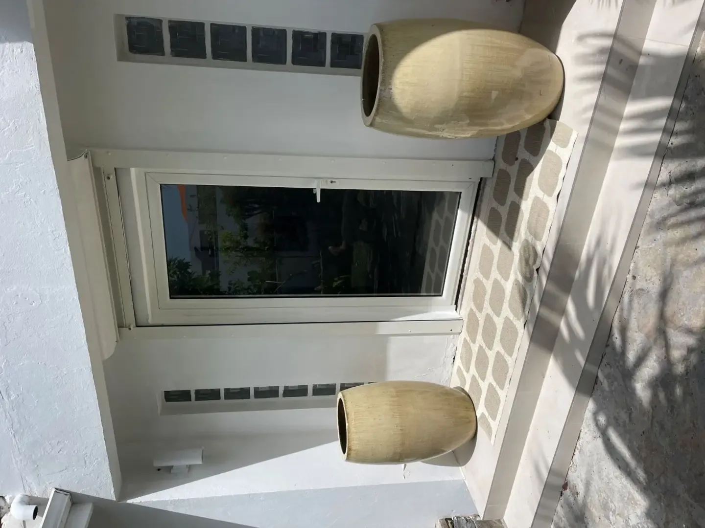 Modern elegance meets island charm at this pristine entrance with designer planters.                                                                                                                                                                                                                                                                                                                                                                                                                                           +
 