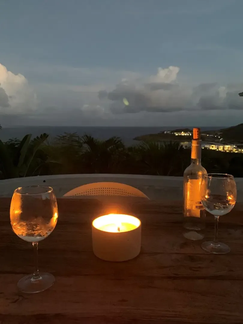 Toast to another perfect day as candlelight flickers and the coastline glitters at dusk.                                                                                                                                                                                                                                                                                                                                                                                                                                      +
 