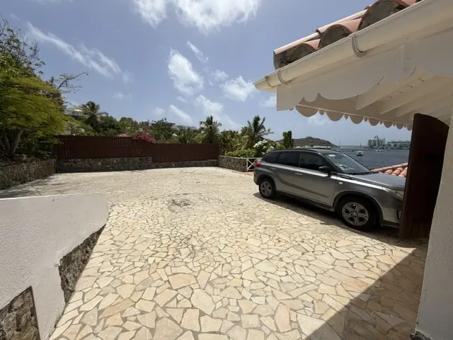Driveway and parking area at Villa Coralita with views toward Oyster Pond.