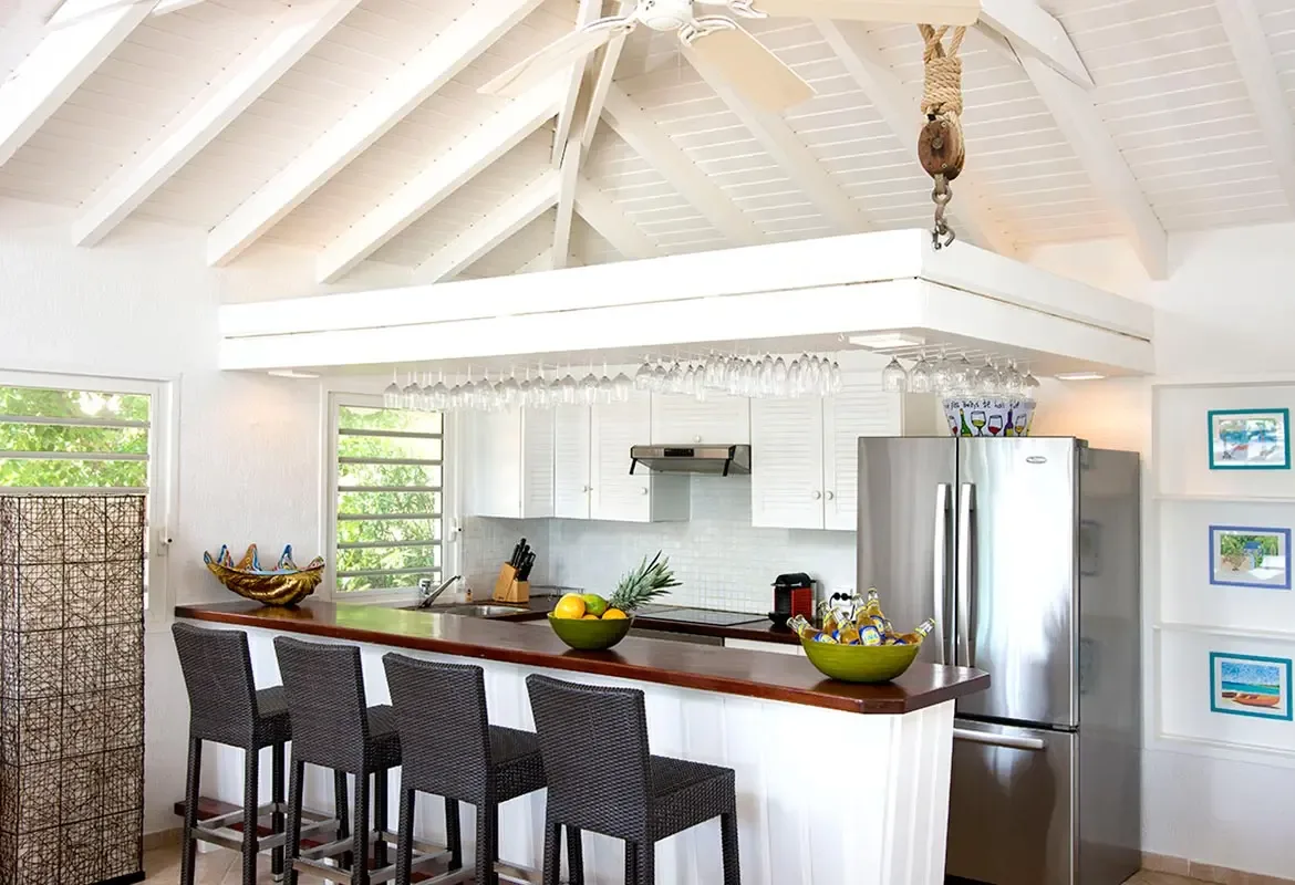 Modern kitchen with breakfast bar and hanging wine rack — where island cooking meets elegant design.