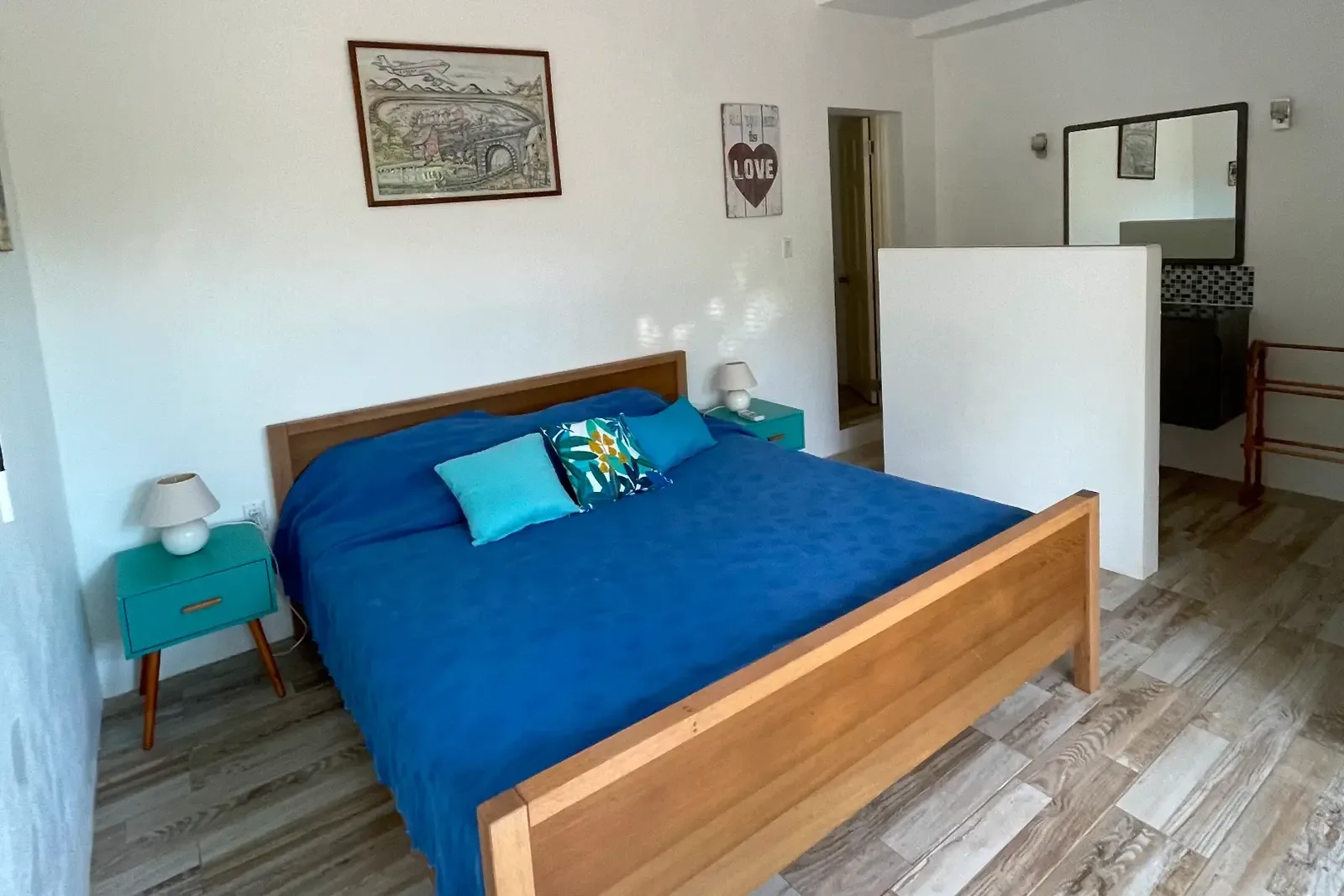 Turquoise furniture with "LOVE" sign — romantic touches for your island escape.