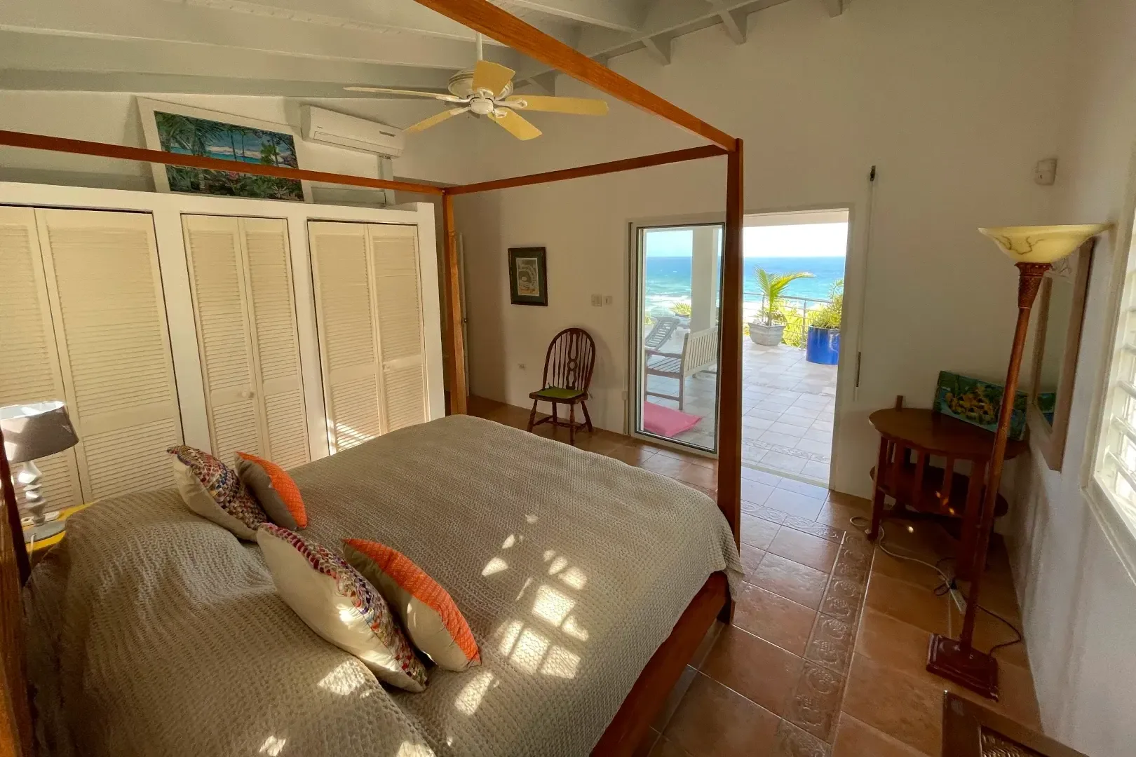 Wake up to the Caribbean — sliding doors open to your private ocean-view terrace.