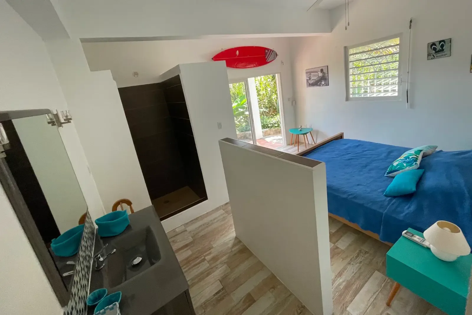 A suite with integrated bathroom and surfboard decor — Caribbean style meets convenience.