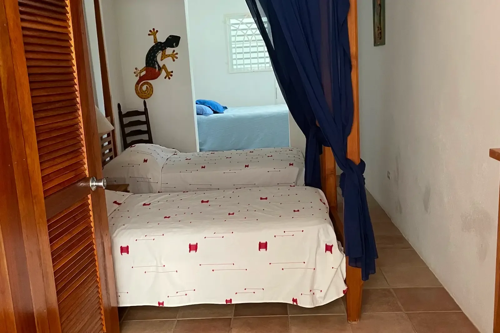 Two twin beds with dark blue canopy — perfect for friends or family sharing.